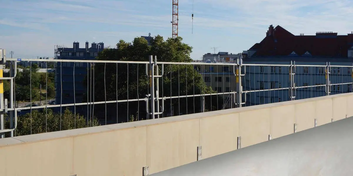 emporary safety parapet wall installed on flat roof for edge protection