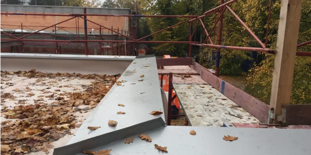 Close-up of a finished white parapet wall ensuring safety and building code compliance.
